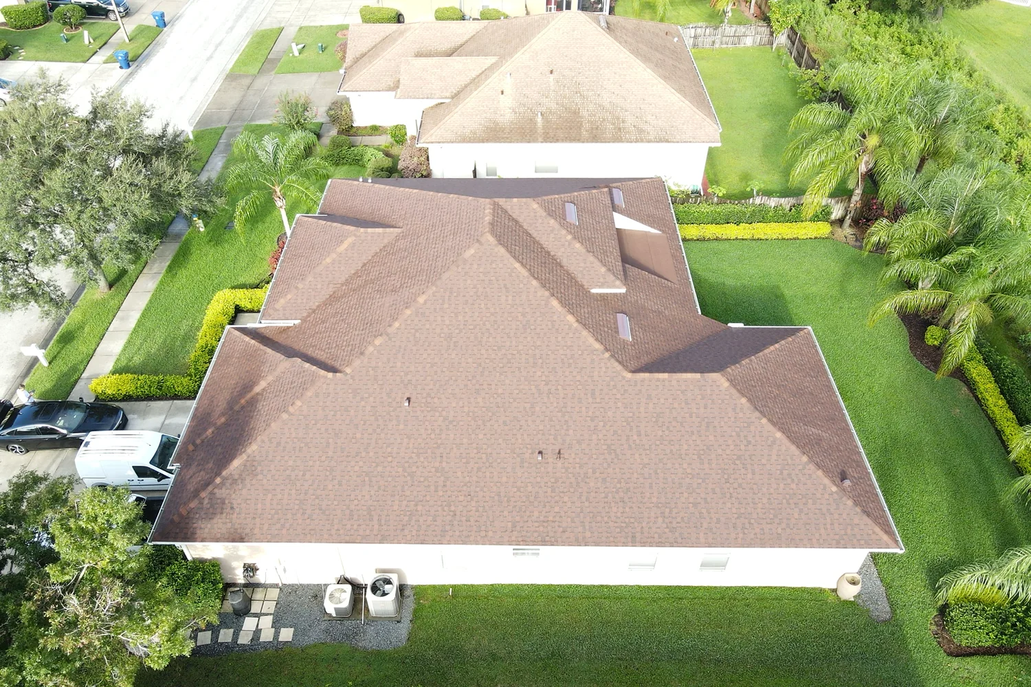 Shingle roof replacement with color coordinated modified bitumen section in Land O' Lakes Florida